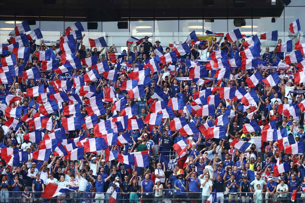 France fans cheer for their team during the 2026 World Cup football tournament quarter-final at Boston Stadium in Foxborough on July 9, 2026. (Photo by Charly Triballeau / AFP)