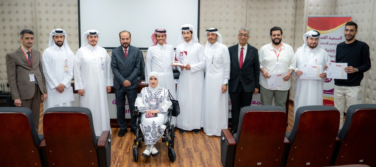 Director of Human Resources at QIIB Sheikh Ali bin Abdullah al-Thani and Executive Director of the Qatar Society for Rehabilitation of Special Needs Amir al-Mulla alongside senior representatives from both organisations pose for a group photo.