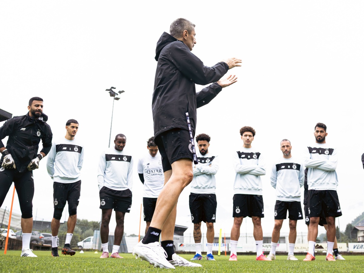 Al Sadd's coach Razvan Lucescu with players during a training session yesterday.