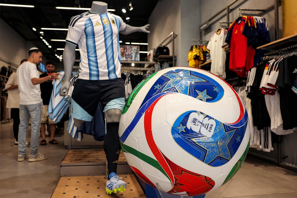 (Files) A replica of the Adidas Trionda, the 2026 FIFA World Cup official football ball, is displayed at a sports shop on June 14, 2026. (Photo by Hazem Bader / AFP)