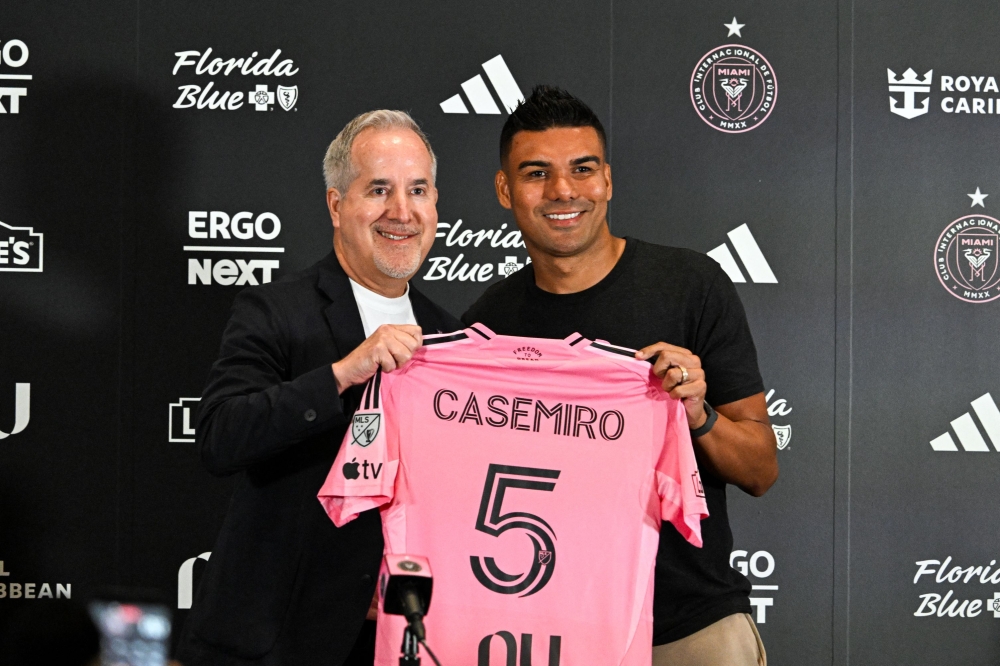 Brazilian midfielder Casemiro poses with Inter Miami managing owner and CEO Jorge Mas, on July 30, 2026. (Photo by Chandan Khanna / AFP)