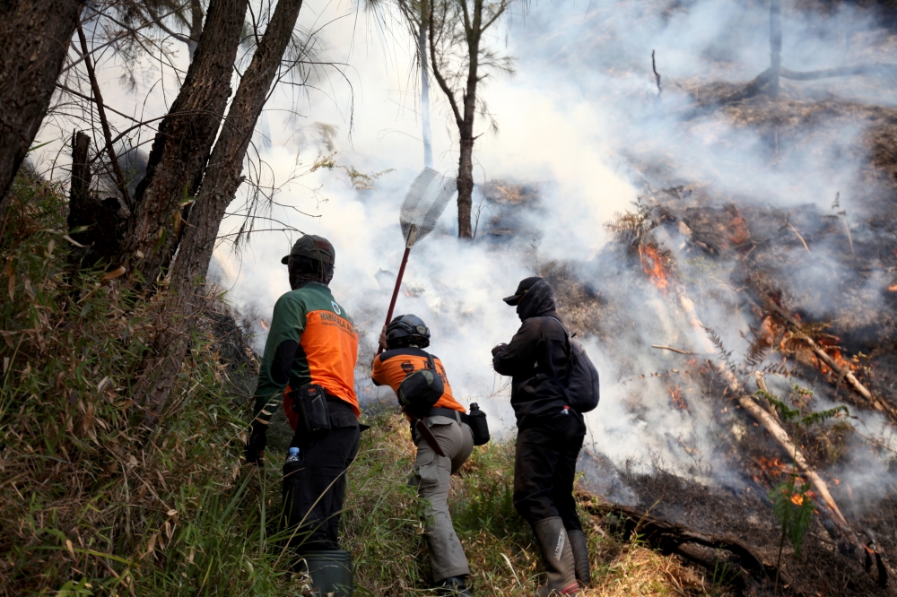 FILE PHOTO: Joint forces battle a fire at Bromo Tengger Semeru National Park, Probolinggo Regency, East Java, Indonesia. (Photo by Bayu Novanta/Xinhua)