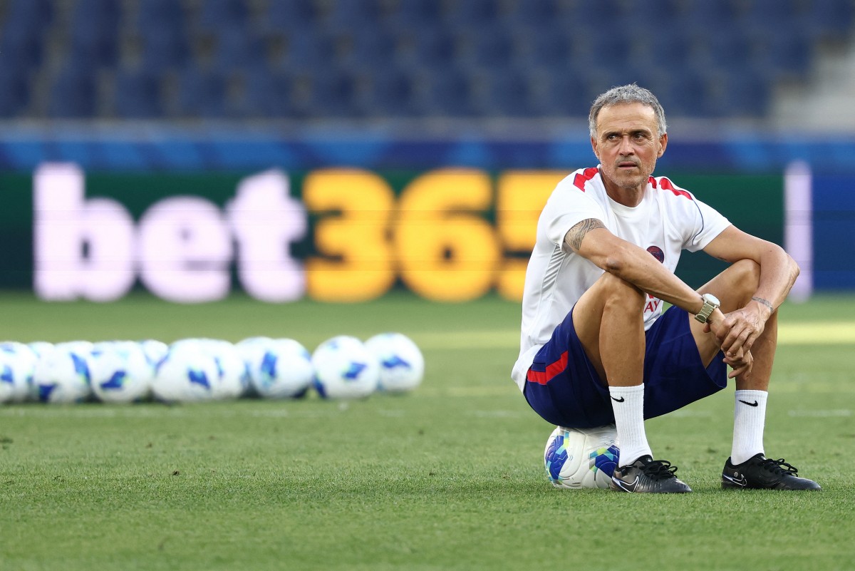 Paris Saint-Germain's Spanish coach Luis Enrique sits on a ball as he oversees a training session of his players on August 11, 2026, the eve of the UEFA Supercup football match between Champions League winners Paris Saint Germain (PSG) and Europa League winners Aston Villa in Salzburg, Austria. (Photo by FRANCK FIFE / AFP)