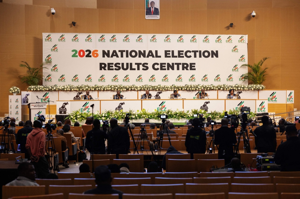 Electoral Commission of Zambia chairperson Mwangala Zaloumis (back row 3rd R) addresses the nation at the 2026 National Election Results Centre in Lusaka on August 14, 2026. Zambia resumed vote counting on August 14 after a nationwide suspension over violence raised tensions nationwide. (Photo by GIANLUIGI GUERCIA / AFP)