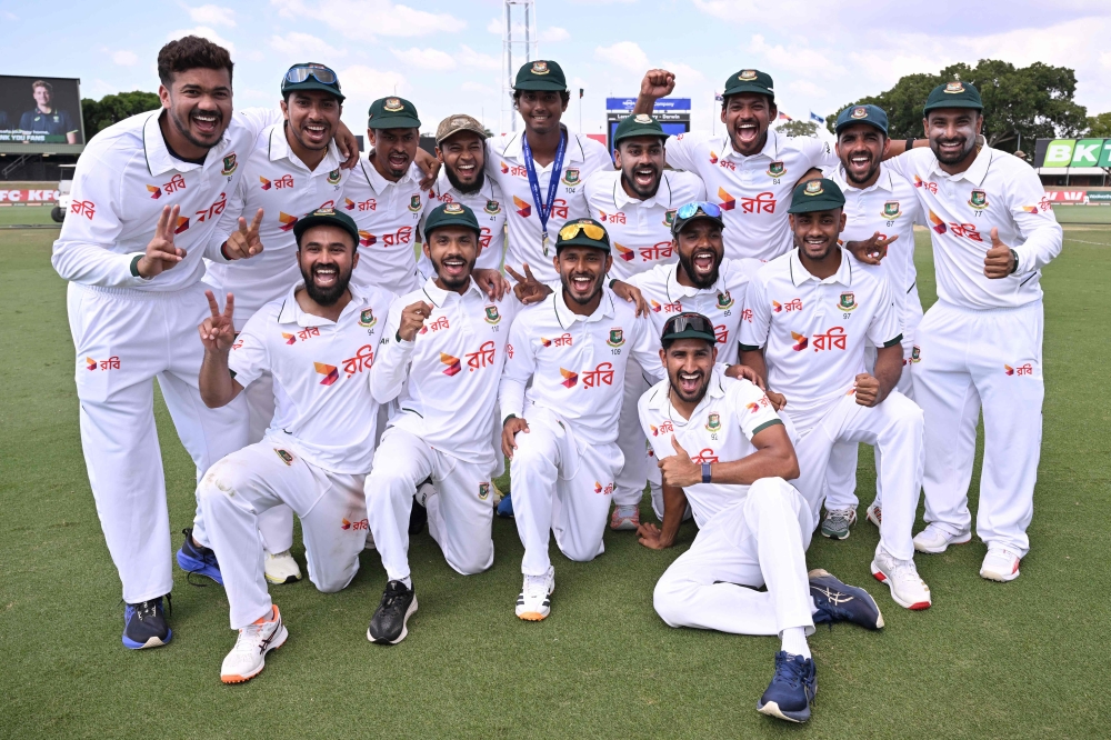 Bangladesh players pose for a photo after their team's victory on the fourth day of the first cricket Test match between Australia and Bangladesh at Marrara Stadium in Darwin on August 16, 2026. (Photo by William WEST / AFP)