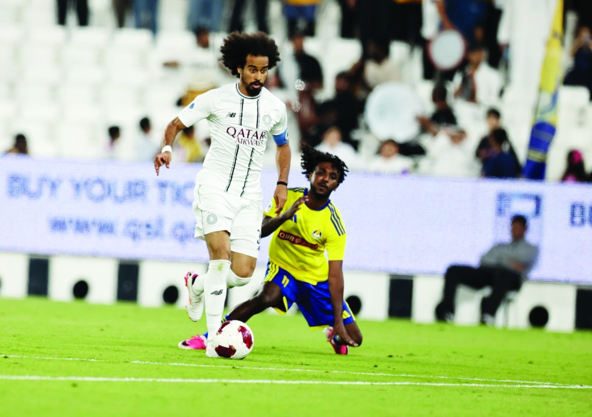 Al Sadd's Akram Afif (left) controls the ball.