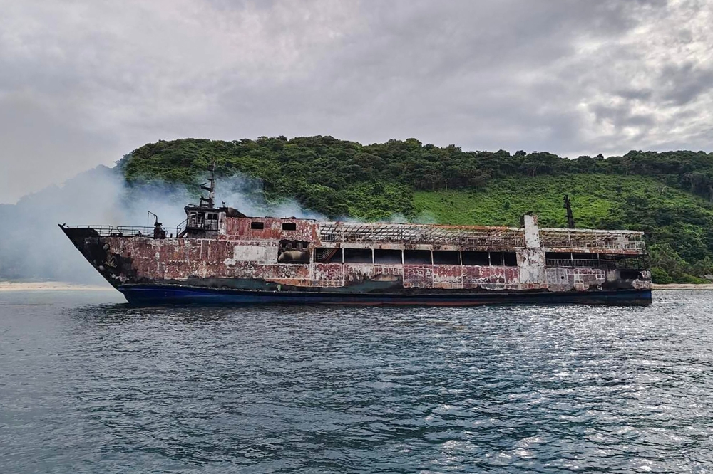 This handout photo taken and received from the Philippine Coast Guard (PCG) on September 10, 2026 shows the ruins of a ferry that caught fire off Palawan. (Photo by Handout / Philippine Coast Guard (PCG) / AFP) 