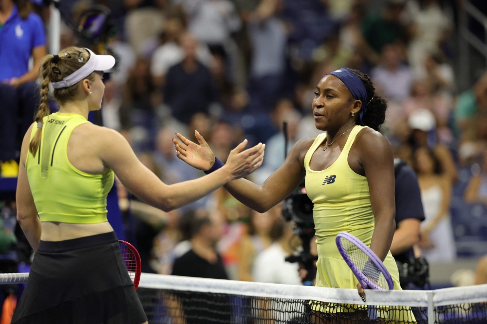 Kazakhstan's Elena Rybakina goes in to hug USA's Coco Gauff after their women's singles semi-final tennis match on day twelve of the US Open tennis tournament at the USTA Billie Jean King National Tennis Center in New York City on September 10, 2026. (Photo by KENA BETANCUR / AFP)