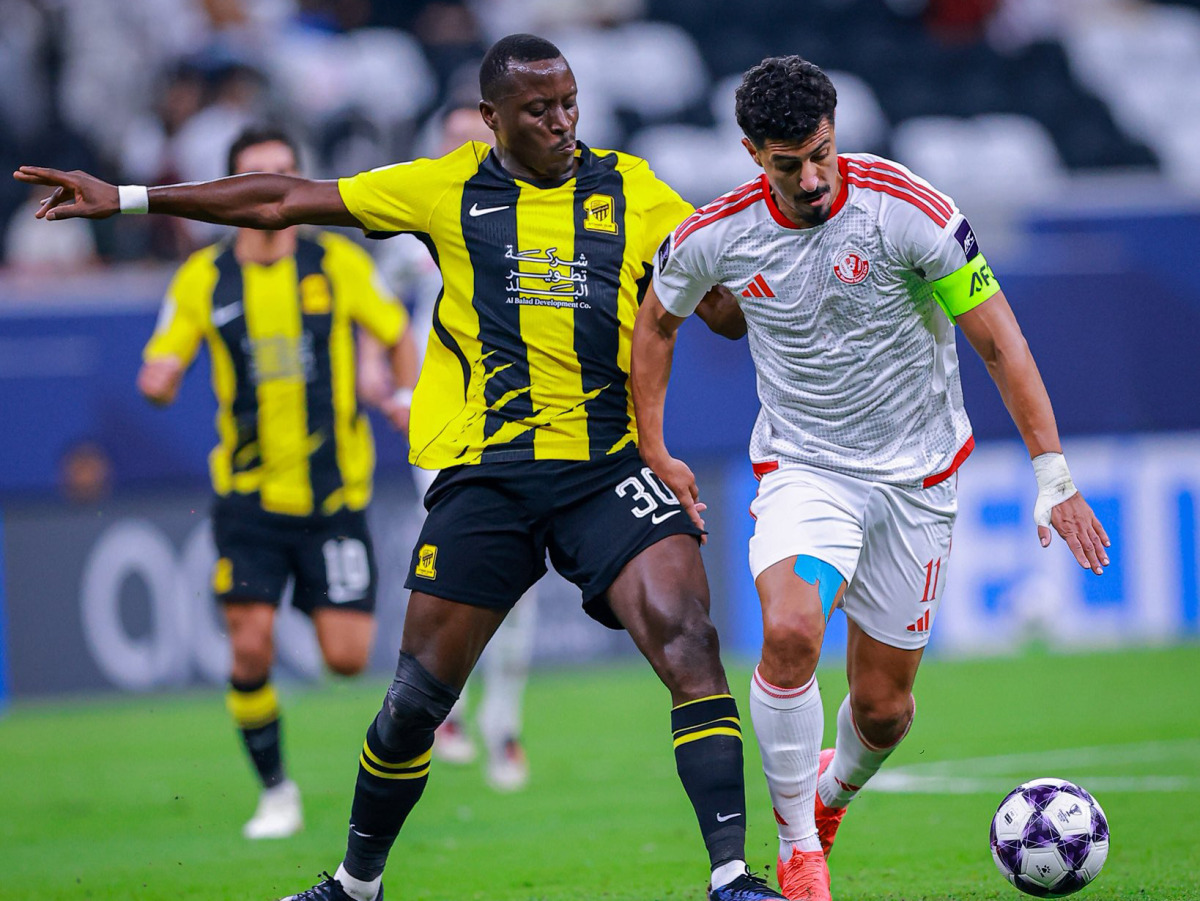 Al Shamal's Baghdad Bounedjah (right) and Al Ittihad's Dion Lopy vie for the ball.