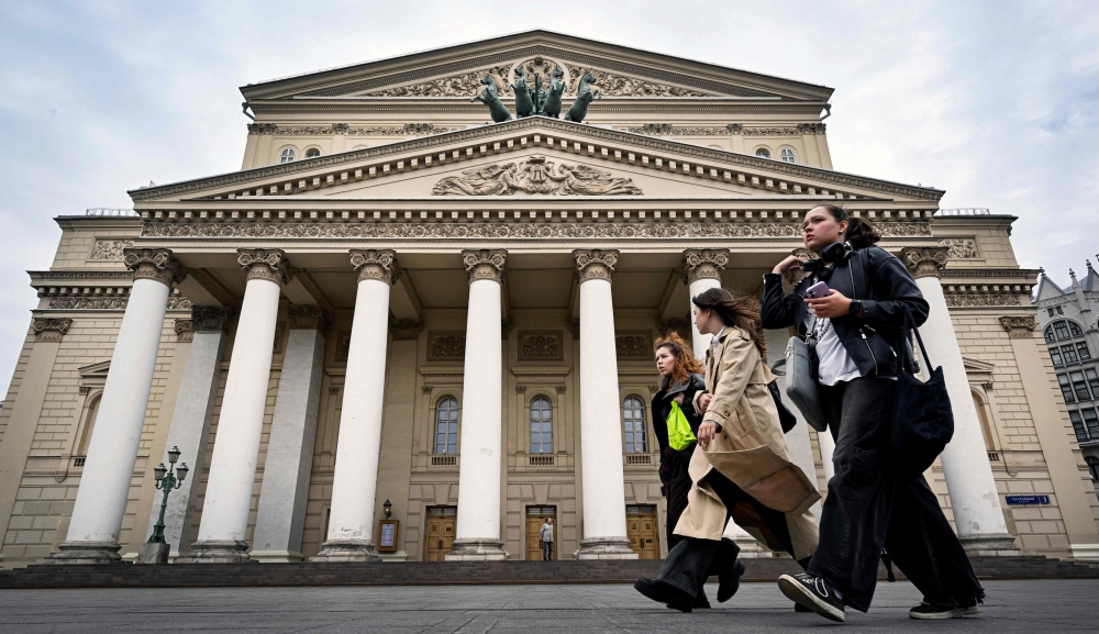 Women walk in front of the Bolshoi Theatre in Moscow on September 24, 2026. (Photo by Alexander Nemenov / AFP)