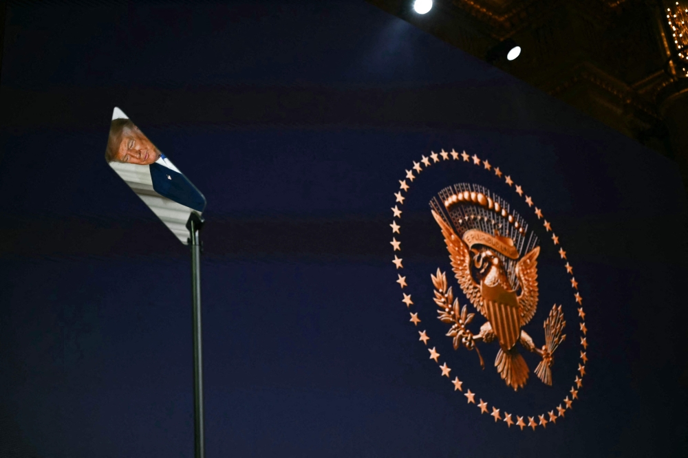 US President Donald Trump is reflected in a teleprompter as he attends an event to unveil the new America.gov website, at the Andrew W. Mellon Auditorium in Washington, DC, on September 29, 2026. (Photo by Kent Nishimura / AFP)
 
