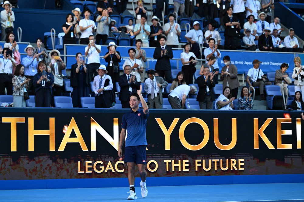 Japan's Kei Nishikori waves to fans as he retires from the sport after his men's singles tennis match against USA's Frances Tiafoe at the ATP Tour Japan Open Tennis Championships at the Ariake Tennis Forest Park in Tokyo on October 1, 2026. (Photo by Rie Kikuchi / AFP)