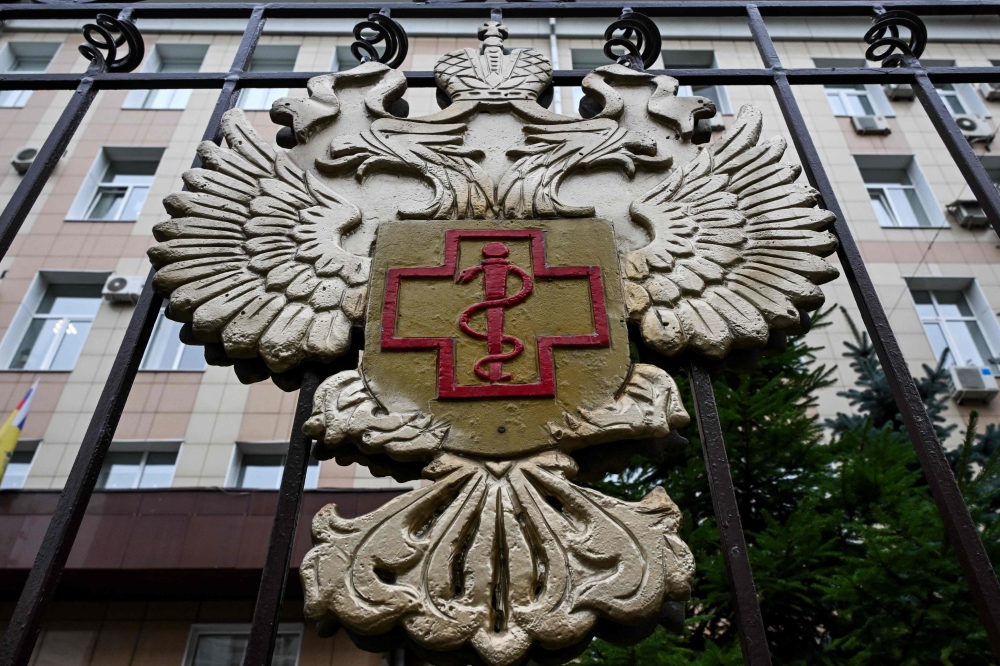 The logo of Russia's consumer and health watchdog Rospotrebnadzor sits on its grounds' fencing in Moscow on October 5, 2026. (Photo by Igor Ivanko / AFP)