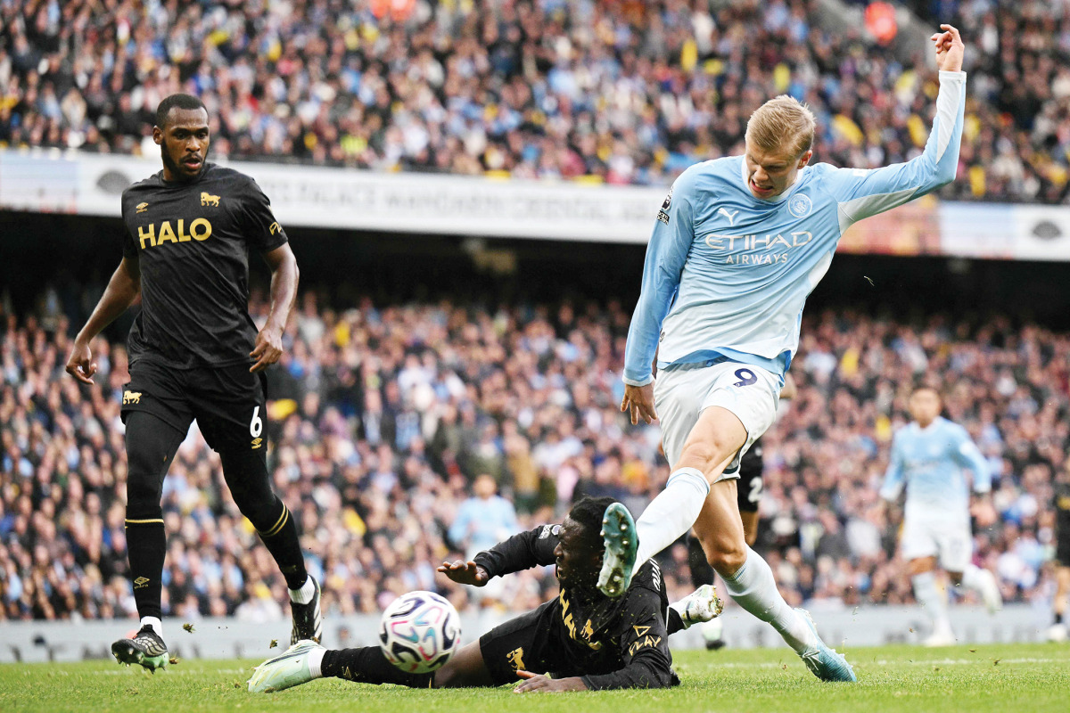 Erling Haaland (right) shoots to score Manchester City’s third goal.
